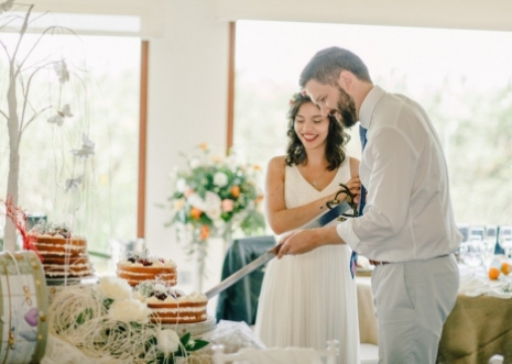 Couple cutting a wedding cake at an elegant reception