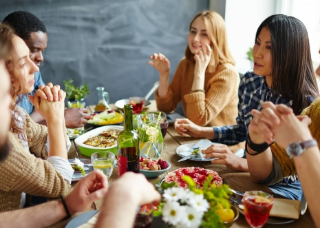 Friends gathered around a table at a social celebration